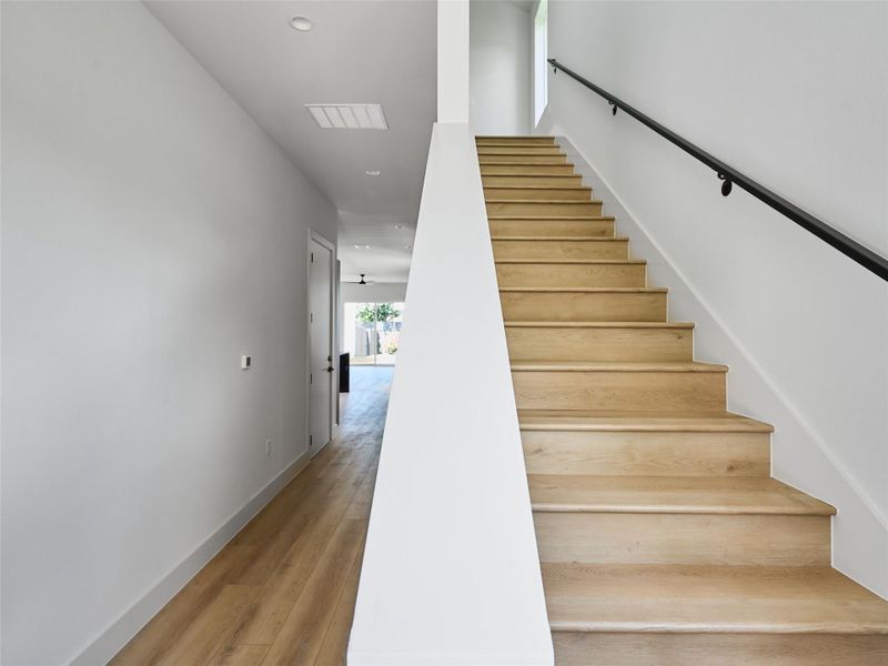Staircase featuring hardwood / wood-style flooring and recessed lighting Staircase featuring hardwood / wood-style flooring and recessed lighting