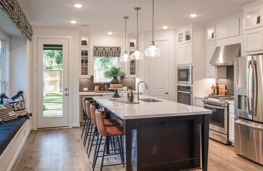 The two toned cabinets in the kitchen are so dramatic and ready to be styled