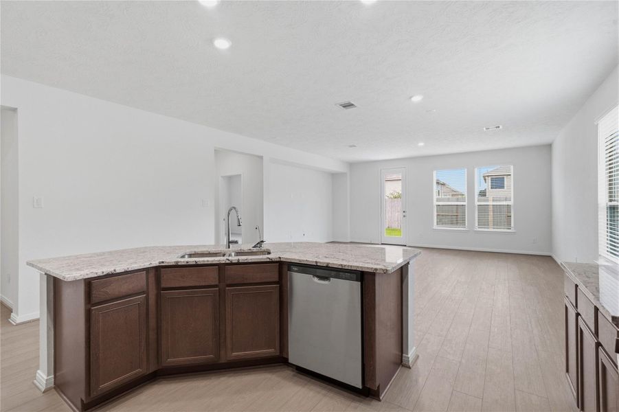 The heart of this home is bathed in abundant natural light and creates a bright, airy atmosphere that enhances the entire open-concept living area. The heart of this home is bathed in abundant natural light and creates a bright, airy atmosphere that enhances the entire open-concept living area.