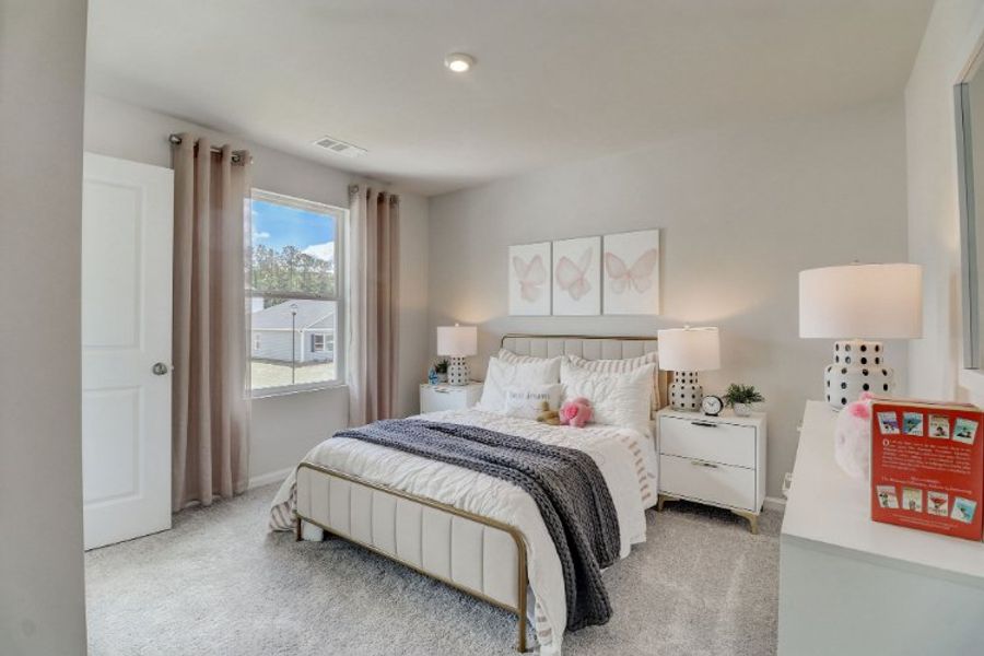 A bedroom with a large window. A bedroom with a large window.