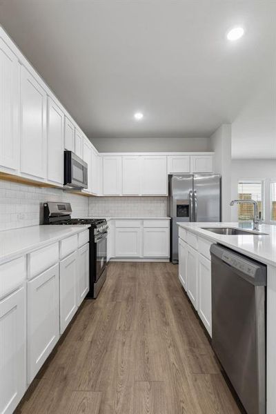 Kitchen in the Oscar home plan by Trophy Signature Homes – REPRESENTATIVE PHOTO