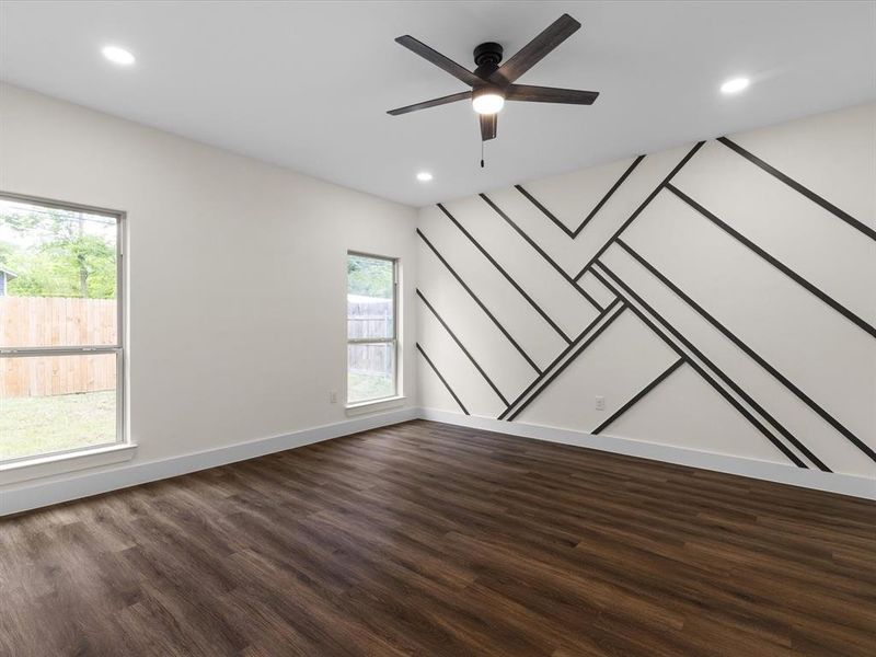 Empty room with ceiling fan, dark wood-style flooring, and recessed lighting