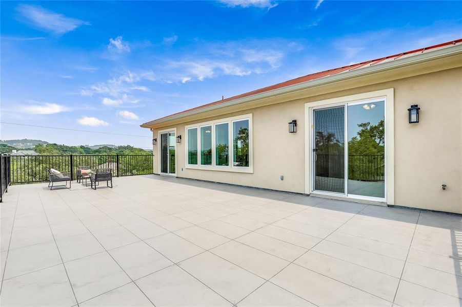 Upstairs deck with panoramic views of green space, Lake Travis, and sunsets.