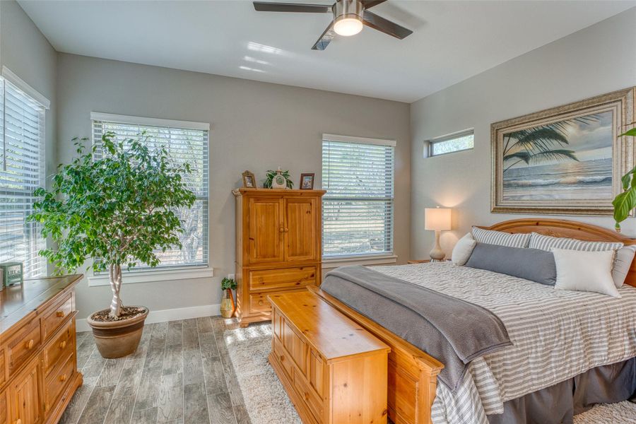 Bedroom with light wood finished floors and a ceiling fan