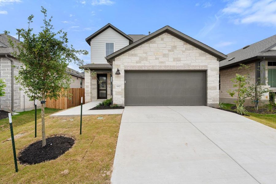 Front exterior of a new home in Heritage, Dripping Springs, TX, highlighting curb appeal (Image 1). Front exterior of a new home in Heritage, Dripping Springs, TX, highlighting curb appeal (Image 1).
