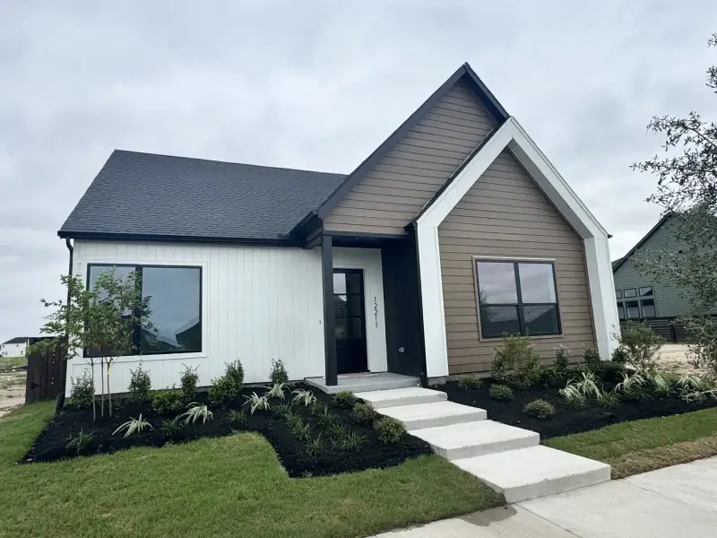 Front exterior of a new home in Bridgeland Central: Emerald Heights - Enclave Row Collection, Cypress, TX, highlighting curb appeal (Image 2). Front exterior of a new home in Bridgeland Central: Emerald Heights - Enclave Row Collection, Cypress, TX, highlighting curb appeal (Image 2).