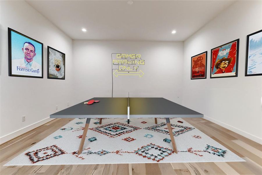 This second rendering features a sleek ping pong table on a patterned rug, surrounded by movie-themed wall art and a "Gamer Parking Only" sign, creating a fun and inviting entertainment space.