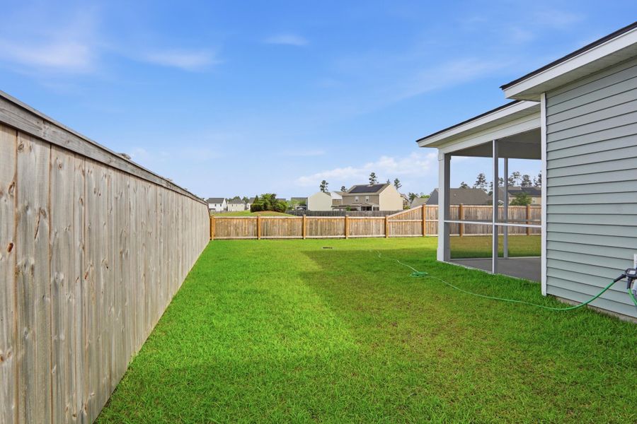 Exterior details and patio area of a home in Sanctuary Cove at Cane Bay, Summerville (Image 26).