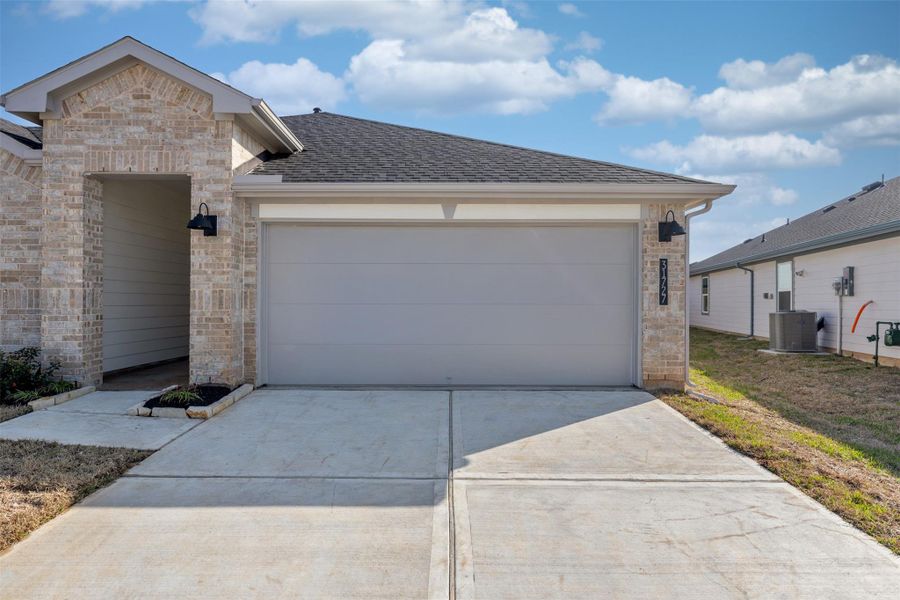 Front exterior of a new home in Tamarron, Fulshear, TX, highlighting curb appeal (Image 24). Front exterior of a new home in Tamarron, Fulshear, TX, highlighting curb appeal (Image 24).