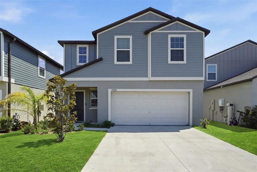 Front exterior of a new home in Connerton, Land O' Lakes, FL, highlighting curb appeal (Image 1). Front exterior of a new home in Connerton, Land O' Lakes, FL, highlighting curb appeal (Image 1).