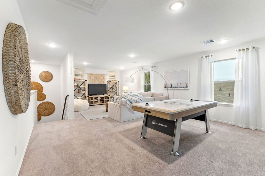 A room with a bed and a desk.