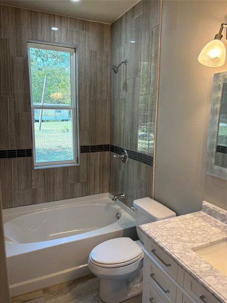 Full bath featuring shower combination and vanity Full bath featuring shower combination and vanity