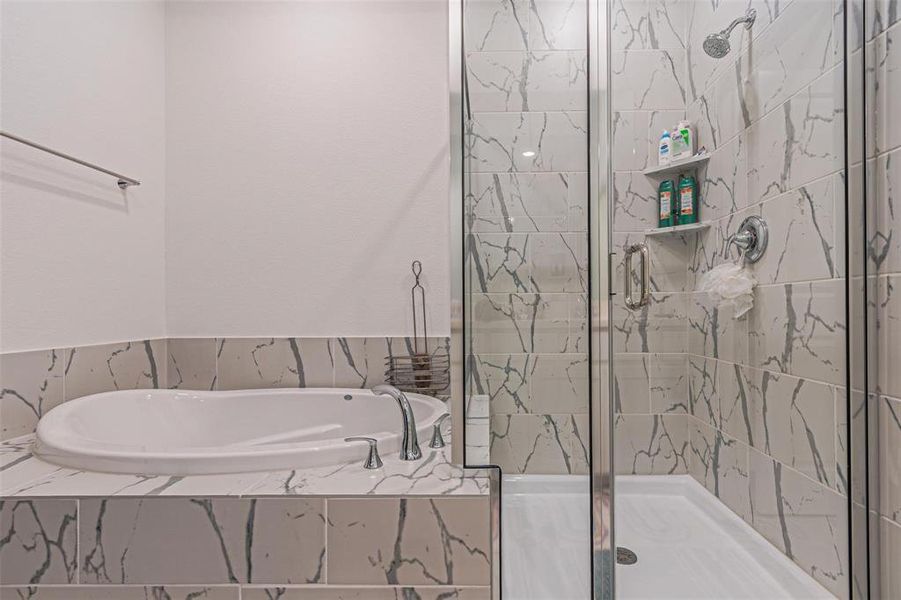 Full bath with a shower stall and a bath