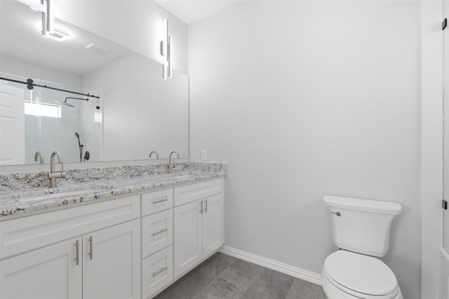 Bathroom with a stall shower and double vanity