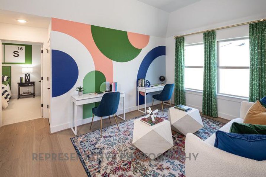 Living room featuring baseboards, a wealth of natural light, and wood finished floors Living room featuring baseboards, a wealth of natural light, and wood finished floors