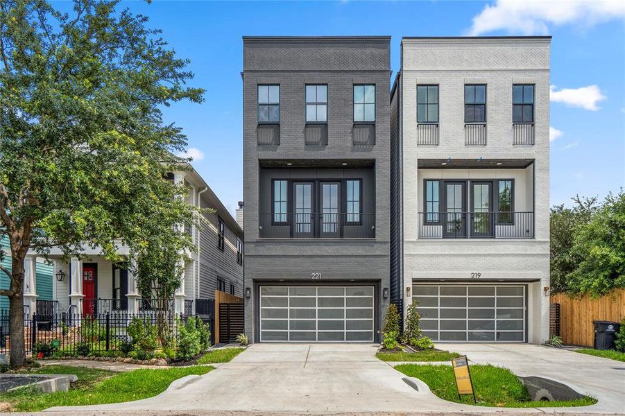 221 W 23rd Street is the dark grey house on the left. Stunning elevation and a long, private driveway to fit 4 cars.