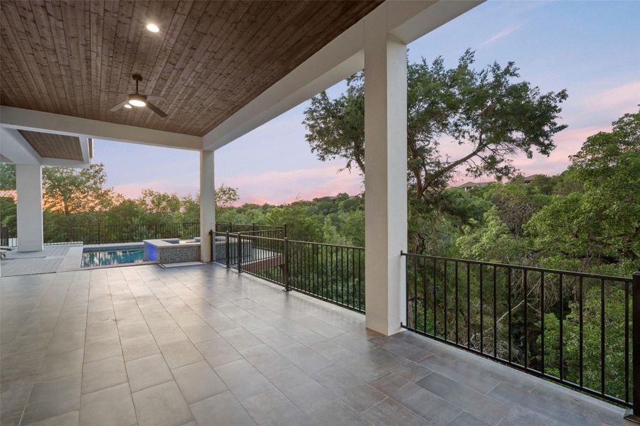 Outdoors, multiple covered terraces invite year-round enjoyment with a resort-style pool and spa, summer kitchen, firepit, and sweeping canyon views.