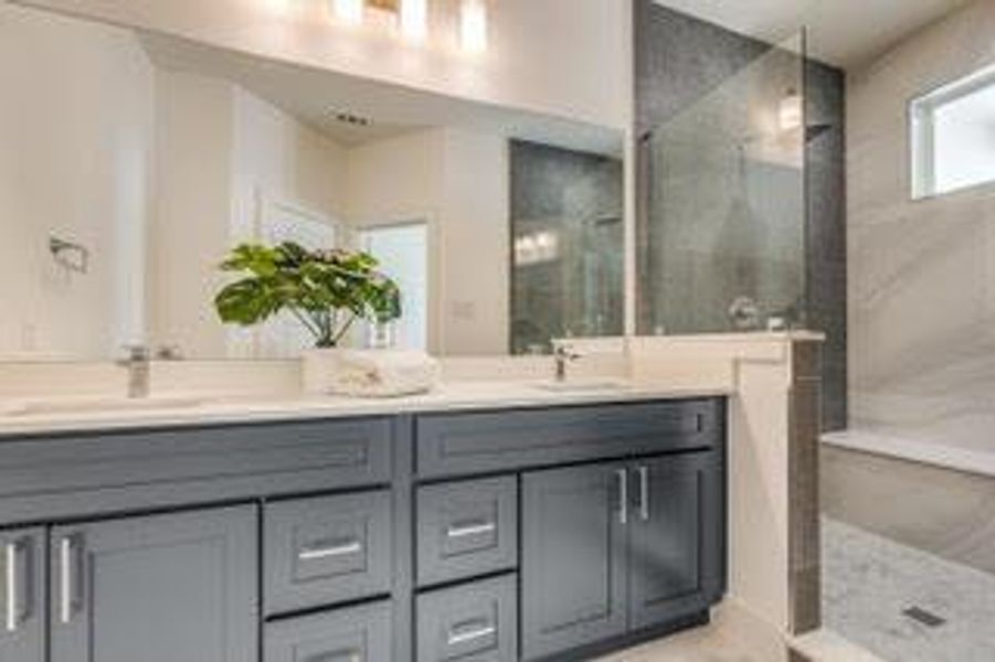 Bathroom with a tile shower and double sink vanity