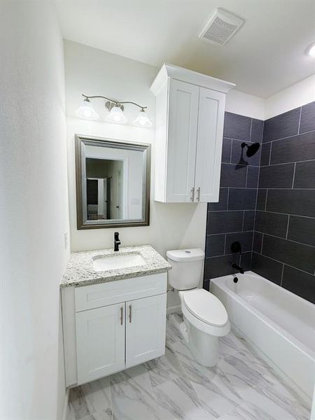 Full bathroom with vanity, bathtub / shower combination, and light marble finish flooring