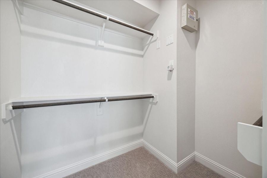 Additional walk-in closet within the primary bathroom, offering extra storage and organization options.
