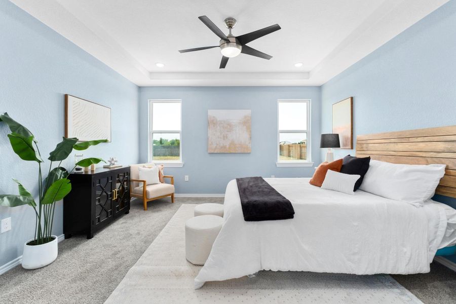 Carpeted bedroom with a raised ceiling, ceiling fan, and recessed lighting Carpeted bedroom with a raised ceiling, ceiling fan, and recessed lighting