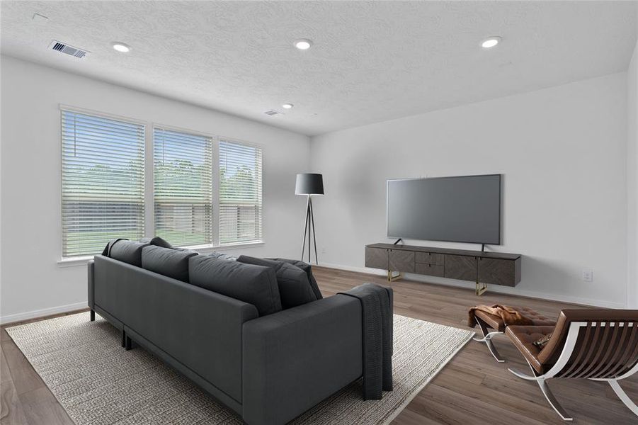 Gather the family and guests together in your lovely living room! Featuring high ceilings, recessed lighting, ceiling fan, custom paint, gorgeous tile floors and large windows that provide plenty of natural lighting throughout the day.