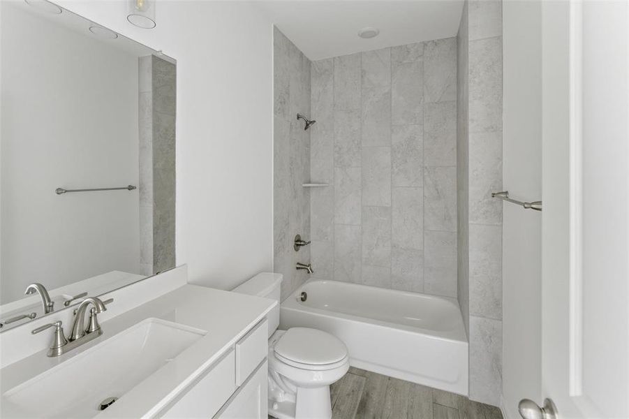 Full bathroom featuring vanity, shower / bathtub combination, and light wood finished floors
