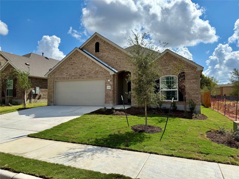 View of front of house with brick siding, concrete driveway, and a garage View of front of house with brick siding, concrete driveway, and a garage