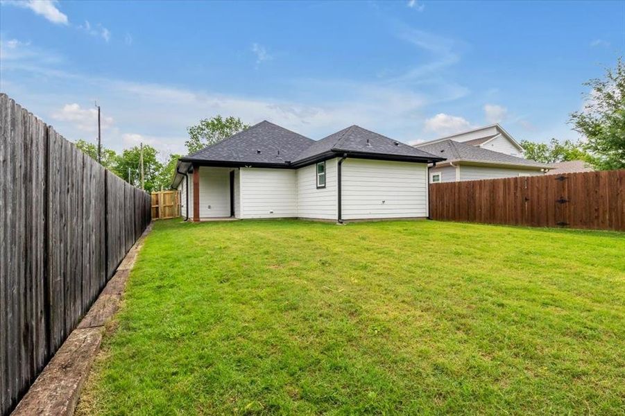 Back of house featuring a lawn