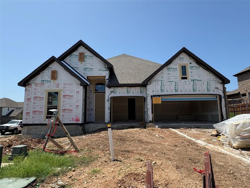 Property in mid-construction featuring a garage, driveway, and a shingled roof Property in mid-construction featuring a garage, driveway, and a shingled roof