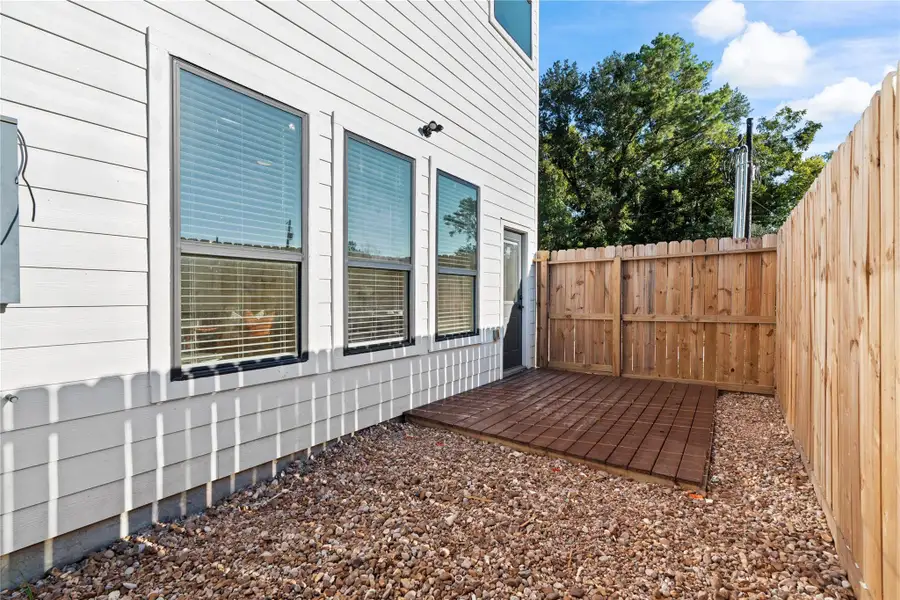 Fenced private backyard with a small deck, a low-maintenance outdoor space ready for grilling or relaxing. Fenced private backyard with a small deck, a low-maintenance outdoor space ready for grilling or relaxing.