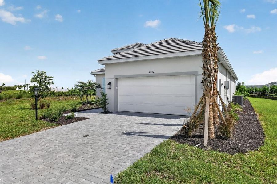 Front exterior of a new home in Skye Ranch Community Group Page, Sarasota, FL, highlighting curb appeal (Image 1). Front exterior of a new home in Skye Ranch Community Group Page, Sarasota, FL, highlighting curb appeal (Image 1).