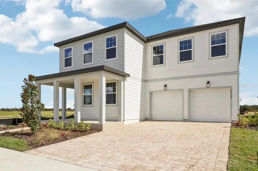 Front exterior of a new home in Trailside, Mount Dora, FL, highlighting curb appeal (Image 2).
