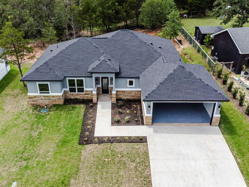 A newly constructed residence showcasing a clean-lined exterior, attached garage, and landscaped entryway. A newly constructed residence showcasing a clean-lined exterior, attached garage, and landscaped entryway.