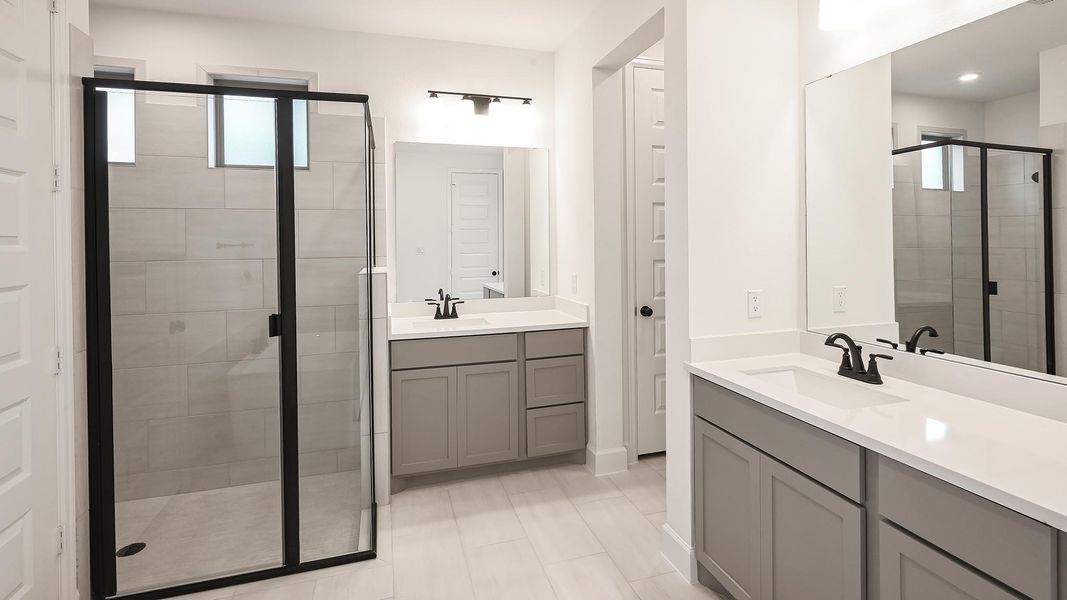 Bathroom with a shower stall and two vanities Bathroom with a shower stall and two vanities