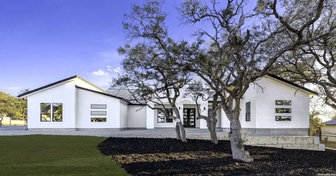 Front exterior of a new home in , Bulverde, TX, highlighting curb appeal (Image 22).
