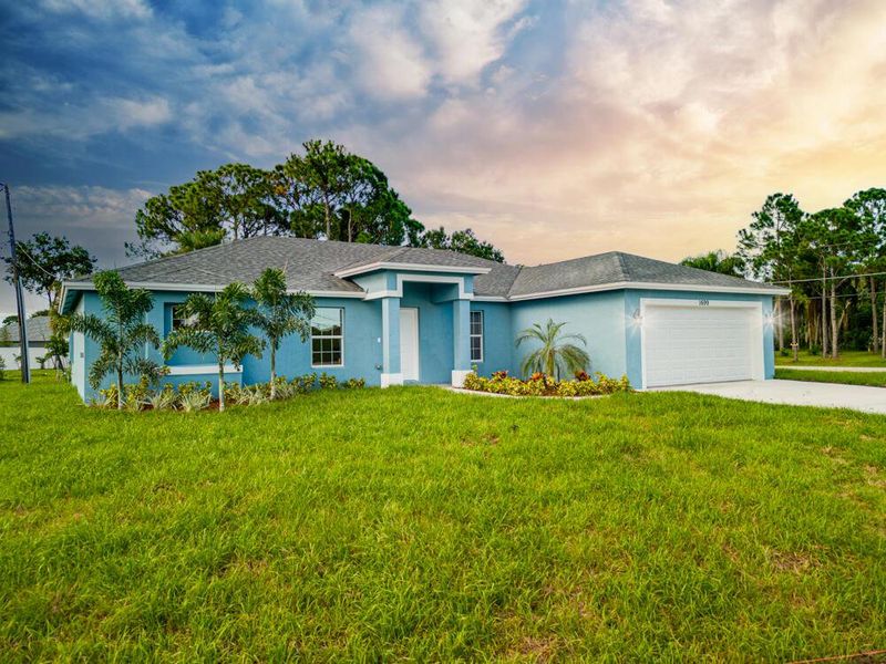 Front exterior of a new home in , Palm Bay, FL, highlighting curb appeal (Image 2).