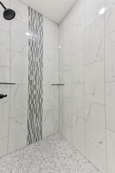 Bathroom featuring tiled shower