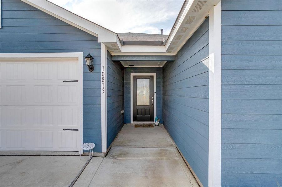 Entrance to property featuring an attached garage