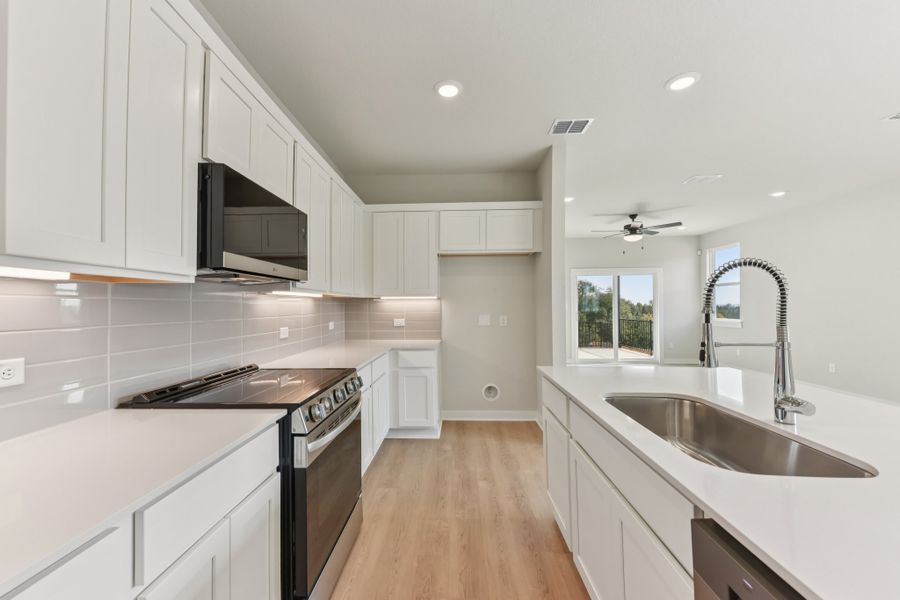 A kitchen with white cabinets. A kitchen with white cabinets.