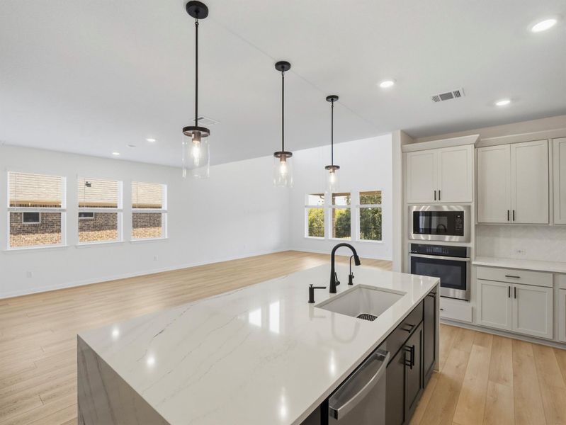 An open-concept living space integrates a well-appointed kitchen with an island, perfect for entertaining. An open-concept living space integrates a well-appointed kitchen with an island, perfect for entertaining.