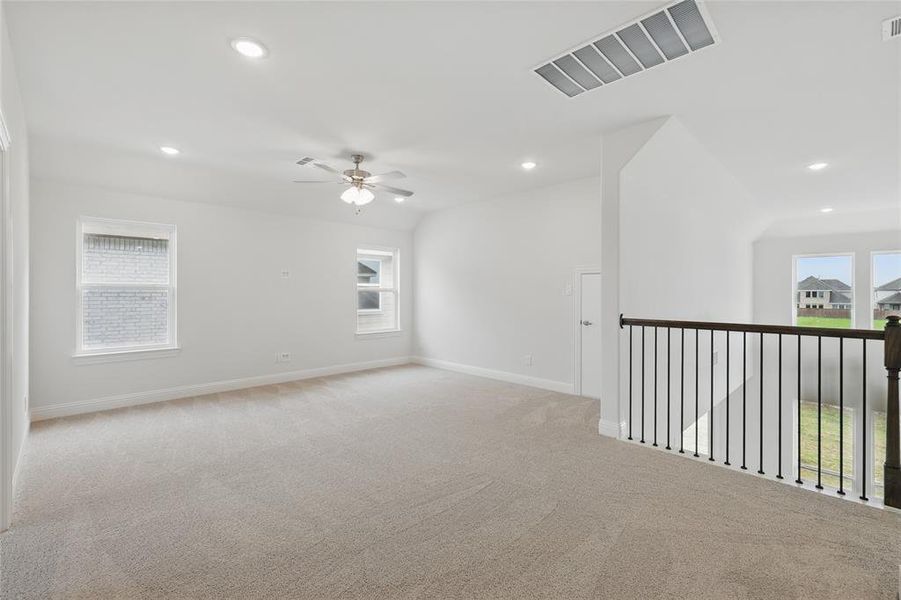 Carpeted empty room featuring recessed lighting, baseboards, ceiling fan, and visible vents