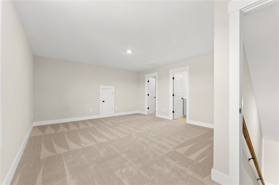 This spacious area offers carpet flooring and incl
