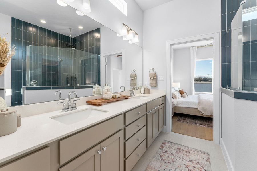Full bathroom featuring double vanity, a tile shower, and ensuite bath Full bathroom featuring double vanity, a tile shower, and ensuite bath