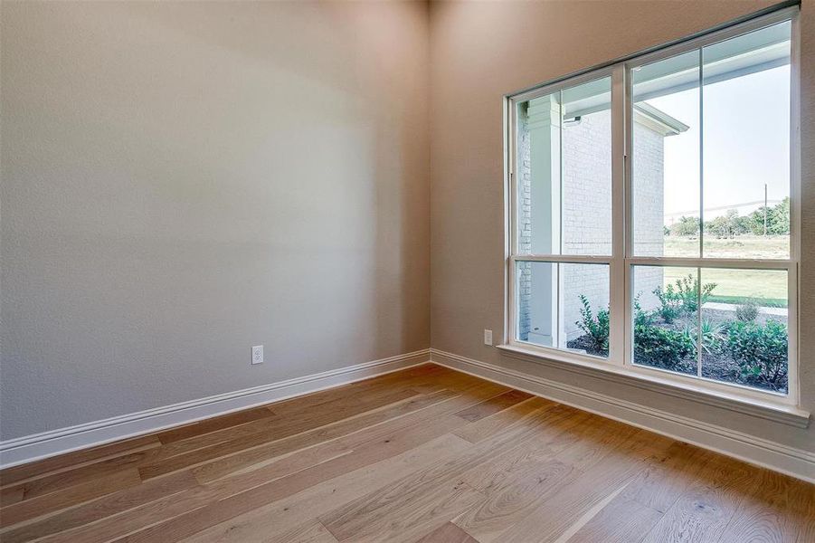 Unfurnished room with light hardwood / wood-style floors