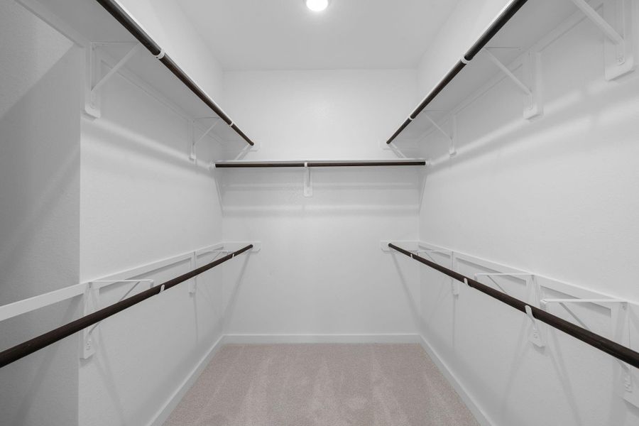 The spacious closet is airy and well-organized, with built-in shelves and hanging rods lining the walls to neatly store clothes, shoes, and accessories. Ample floor space allows for easy movement, while soft lighting and possibly a full-length mirror add both functionality and a touch of luxury. The spacious closet is airy and well-organized, with built-in shelves and hanging rods lining the walls to neatly store clothes, shoes, and accessories. Ample floor space allows for easy movement, while soft lighting and possibly a full-length mirror add both functionality and a touch of luxury.