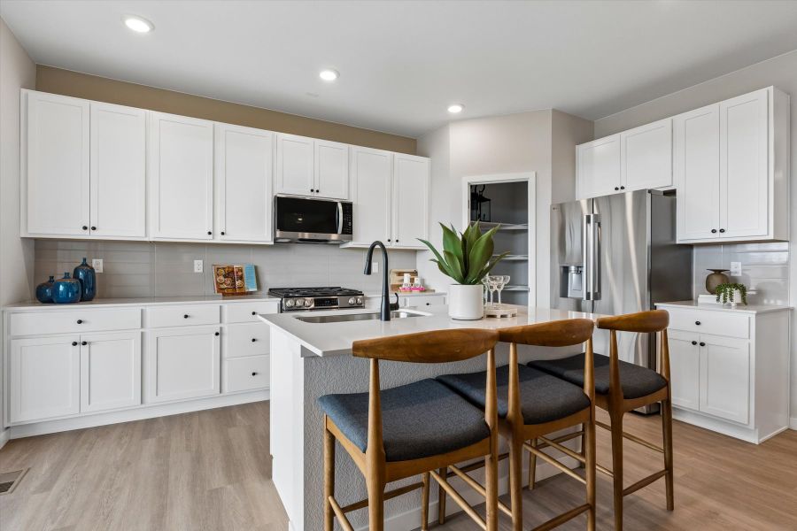 A kitchen with white cabinets. A kitchen with white cabinets.