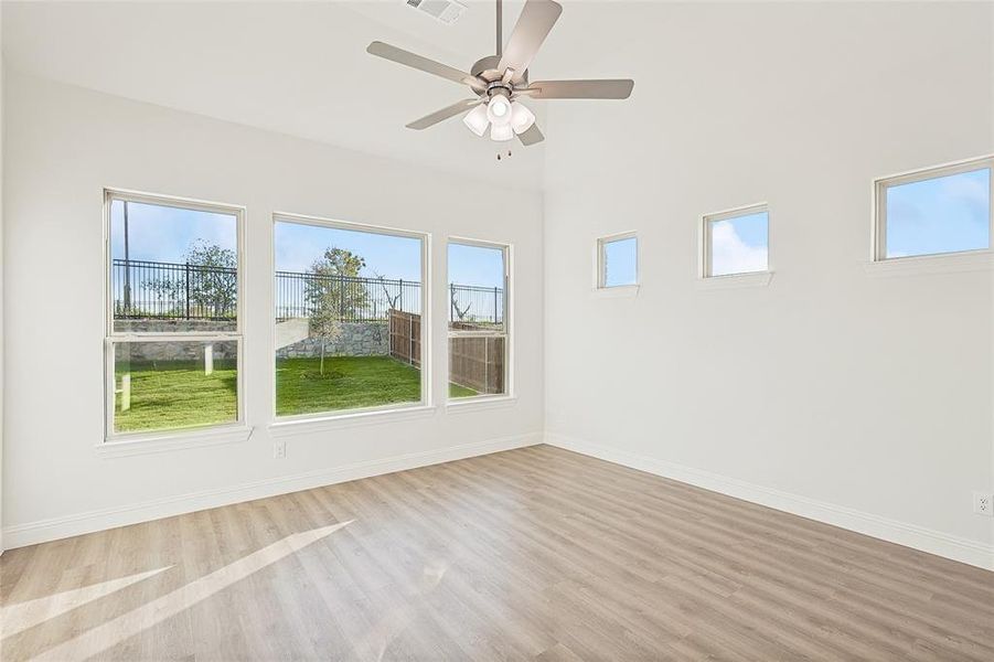 Spare room with light hardwood / wood-style floors and ceiling fan