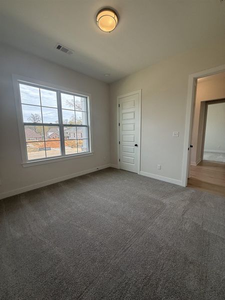 Carpeted empty room featuring baseboards