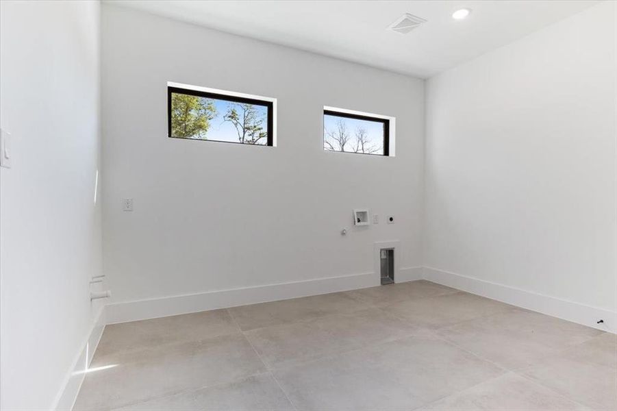 Laundry room with hookup for a washing machine, gas dryer hookup, electric dryer hookup, and light tile floors